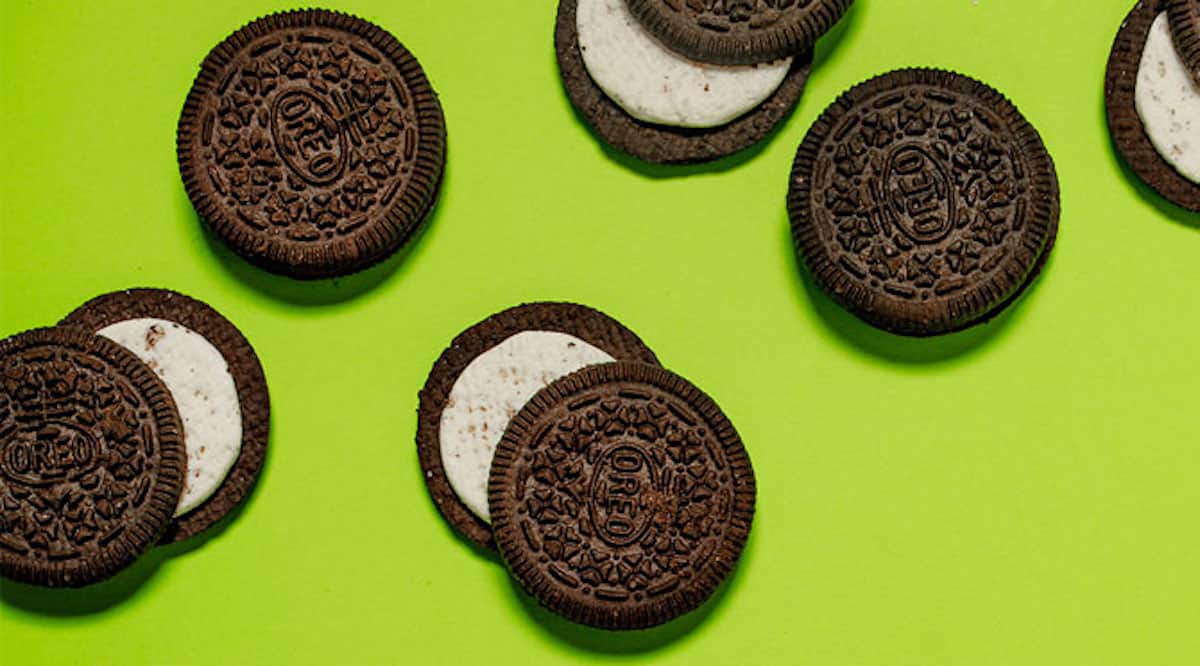 Oreos, some whole, some split on a green background.