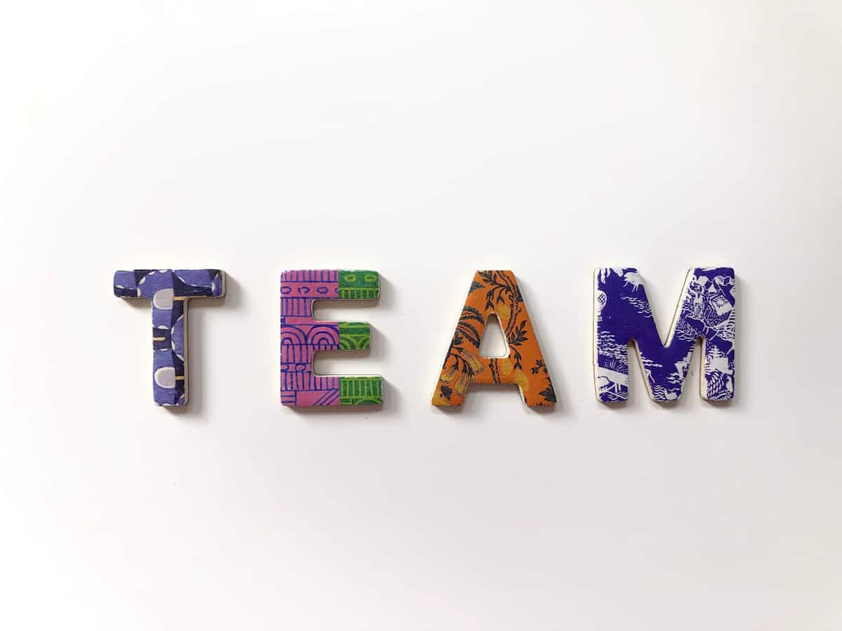 The word team spelled out in colorful tiles